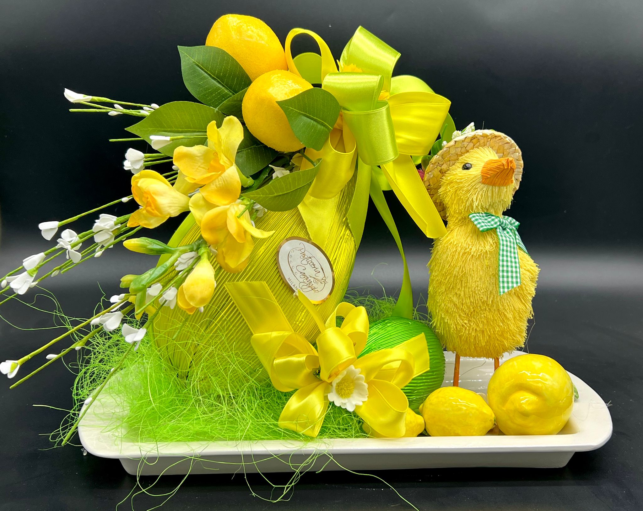 Uovo di cioccolato verde con fiocco giallo e pulcino decorativo, pasticceria Caravaggio Pasqua 2024