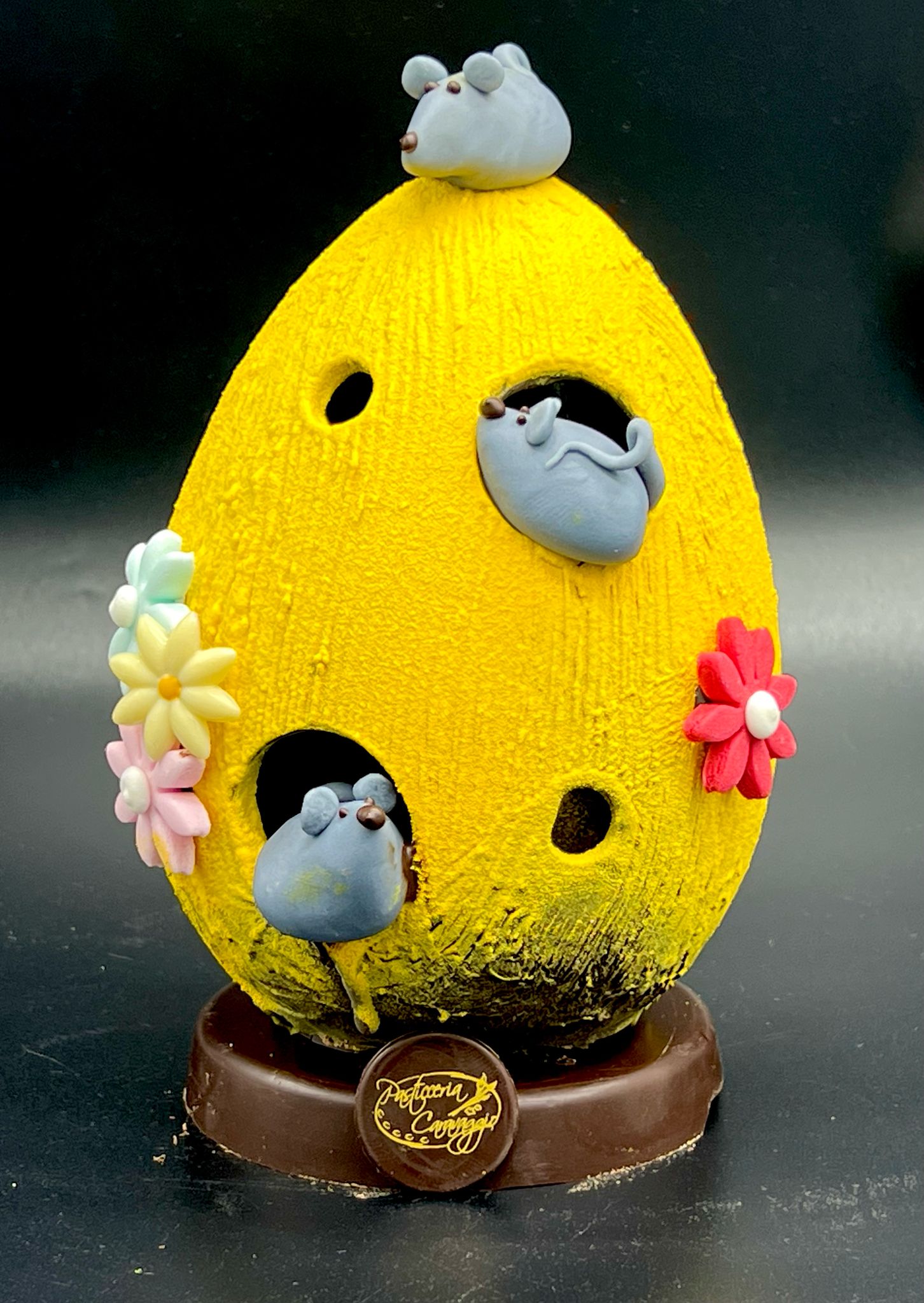 Uovo di cioccolato giallo decorato con topolini di pasticceria Caravaggio, Pasqua 2025
